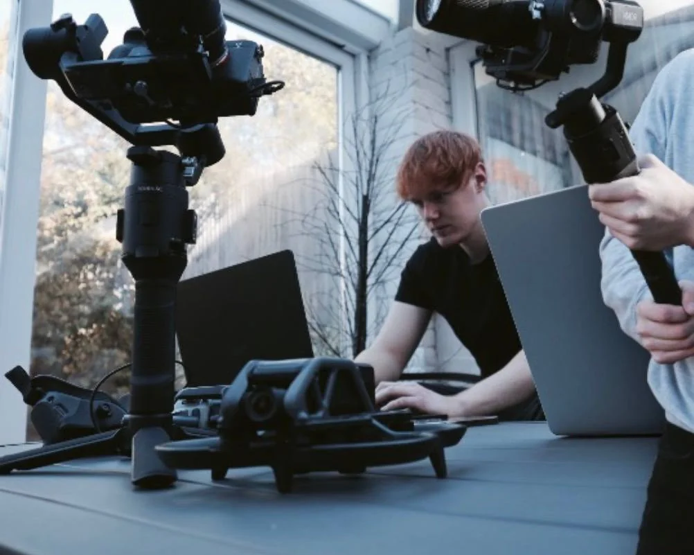 Early filming work under the Indus name, with cameras on gimbals and a drone on the desk